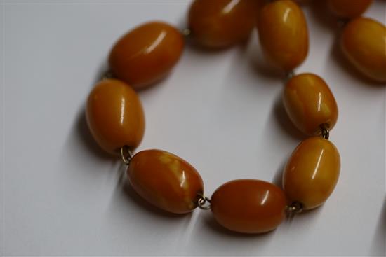 A Persian gilt metal and graduated amber bead tassel drop necklace, 180cm incl. tassel.